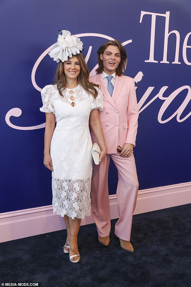 Elizabeth Hurley Shines in White Lace Gown with Lookalike Son Damian at 2024 Crown Oaks Day